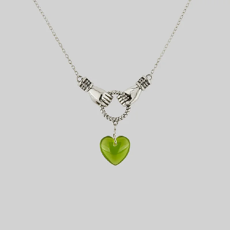 Spiral coil necklace-UNITE. Hand Grasping Green Glass Heart Necklace - Silver